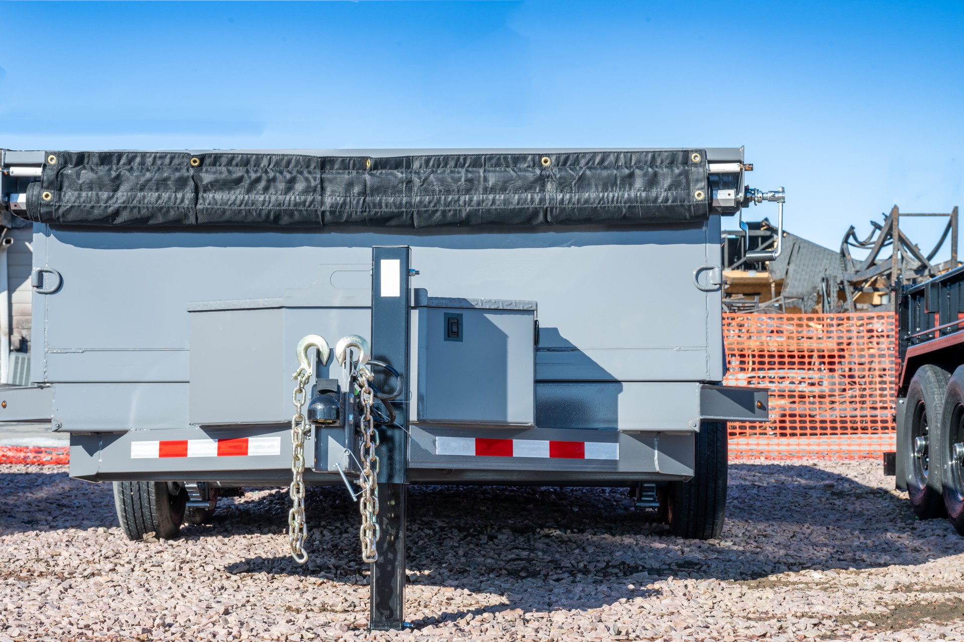 Selective focus on parked flat bed utility trailer with sides