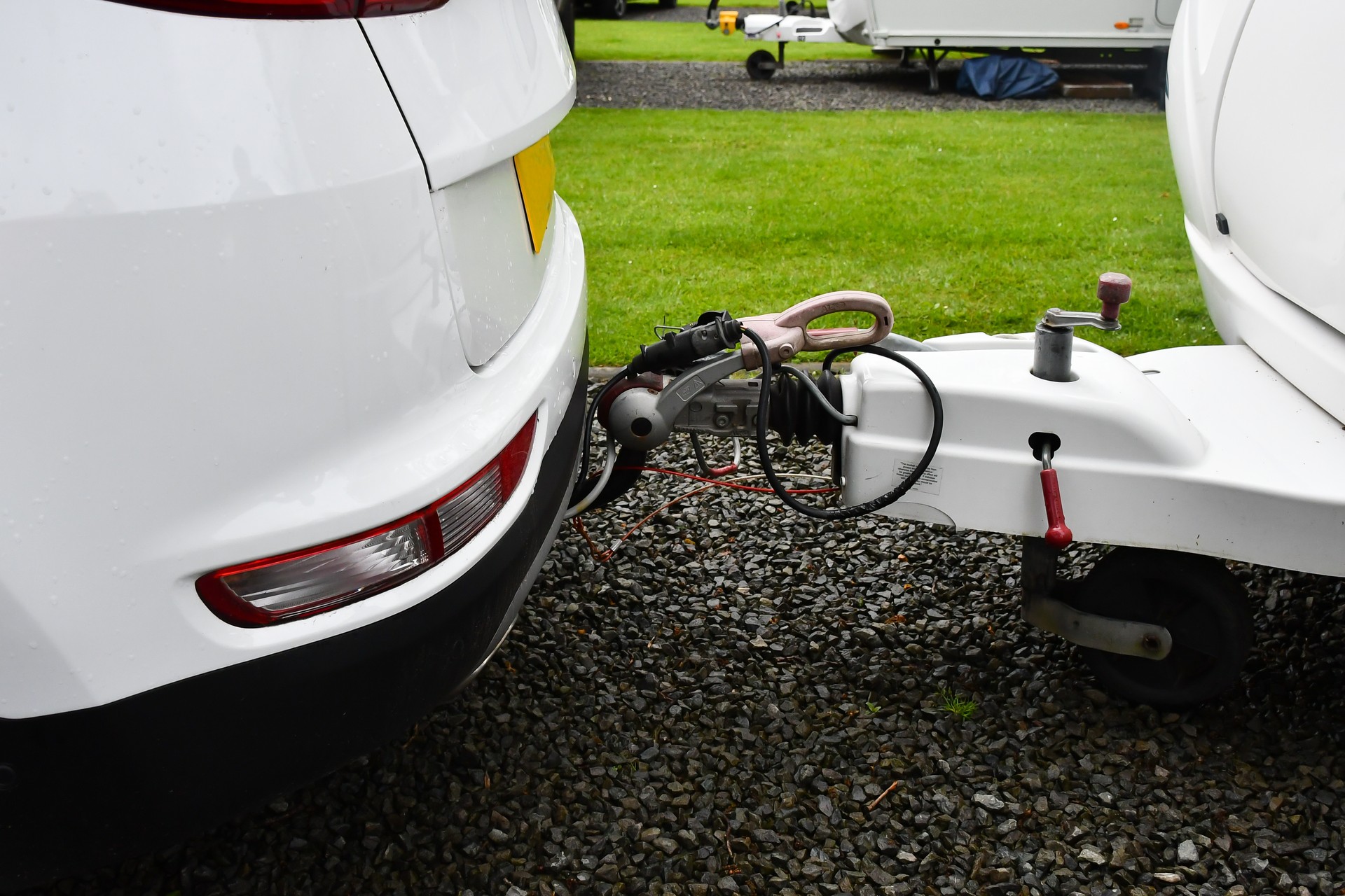 Close up shot of car attached to caravan by tow bar with jockey wheel and cables all sorted ready to travel home from Caravan Park and vacation.